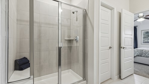 Primary bathroom with standup shower with seating bench
