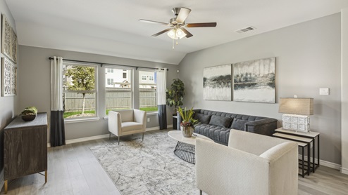 Large living room area with windows and beautiful furniture