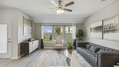 Large living room area with windows and beautiful furniture
