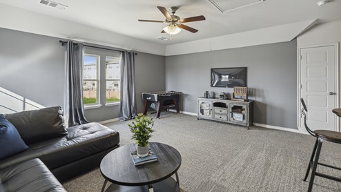 Large media room with media furniture and large window
