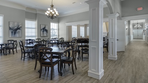 Inside Williamsburg's amenity center showing plenty of tables and seating