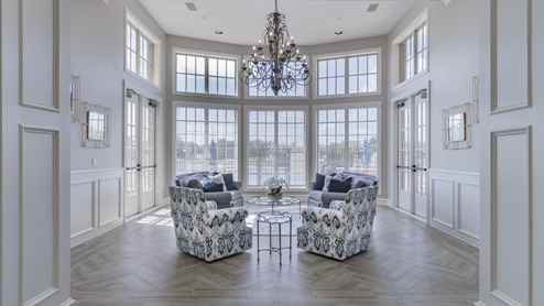 Interior of Williamsburg's amenity center with large windows and lounge furniture