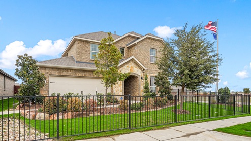 4108 Plateau Drive model home at Lakewood Trails in Forney, TX with brown bricks and two-story.