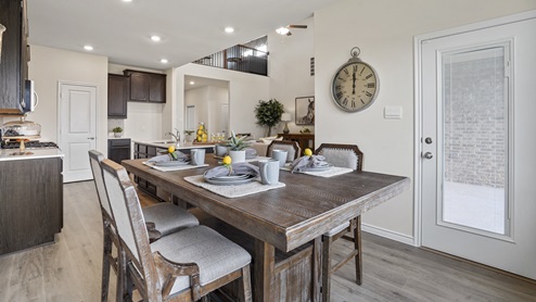 breakfast nook with table next to kitchen and back door