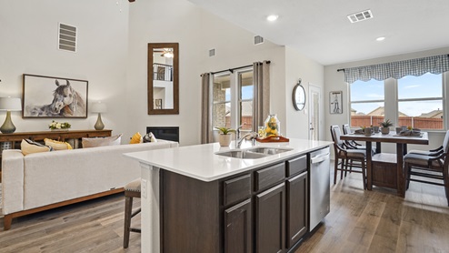 large kitchen overlooking living room and breakfast nook with window