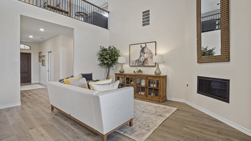 large living room with couch and furniture with view into upstairs with railing