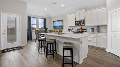 kitchen with white counters and cabinets with breakfast nook including large window