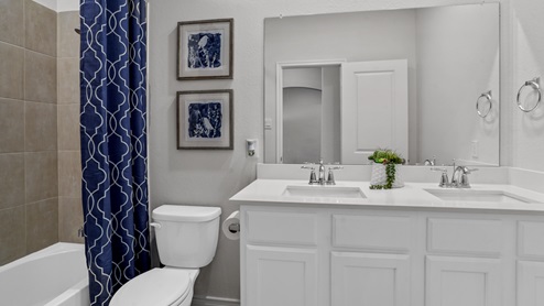 large primary bathroom with vanity and mirror