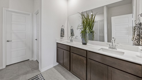 large primary bathroom with elongated vanity and sink