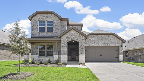 Two story exterior elevation of home with light brown brick and white stone