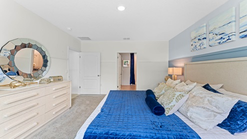 Guest bedroom with bed, nighstands and a roomy closet for storage.