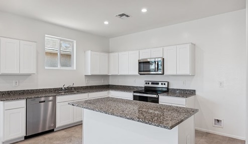 blackstone kitchen with white cabinets and kitchen island