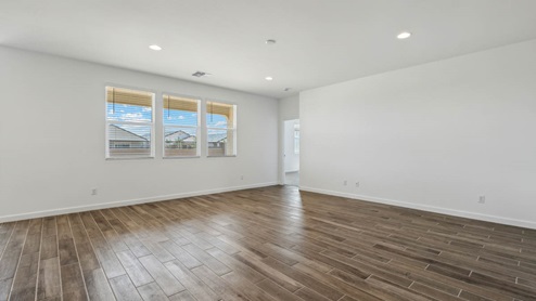 A well-organized living room that includes a kitchen and dining area, creating a warm and welcoming environment for gatherings.