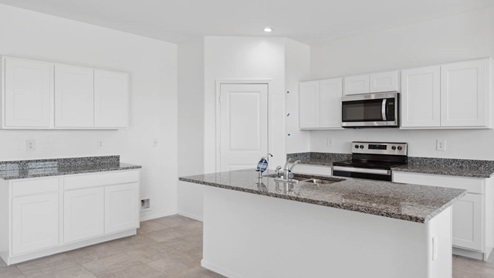 Open concept kitchen with walk-in pantry and granite countertops