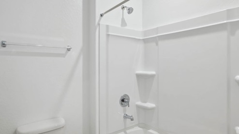 A well-designed bathroom emphasizing functionality in between bedrooms.