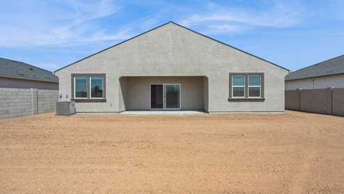 Large fenced-in backyard with a covered patio, perfect for outdoor entertaining.