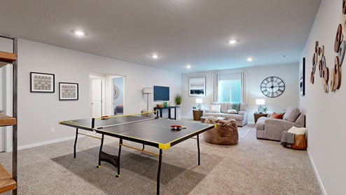 Large finished basement with a ping pong table in the Neuville