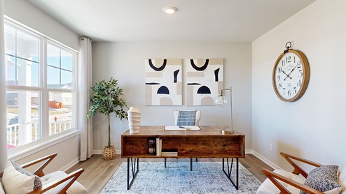 Front office with wooden desk and chairs in the Bellhaven floor plan