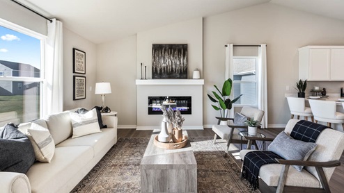 Spacious living room with vaulted ceilings and a wall-mounted electric fireplace