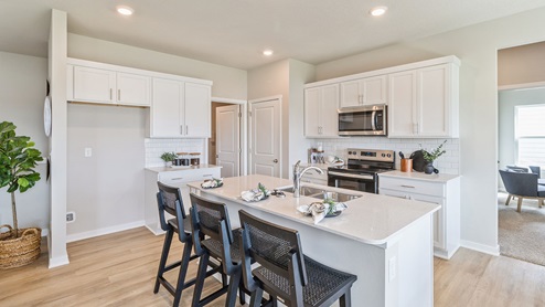 white kitchen with island and quartz countertops