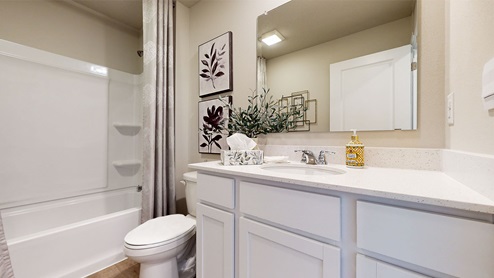 First bedroom with large mirror and bathtub