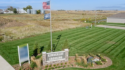Monument sign and United States Flag at the entrance of Kimberley Crossing