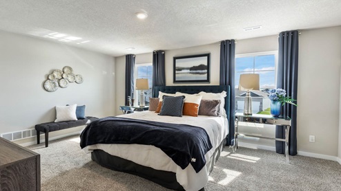 big primary bedroom with two windows