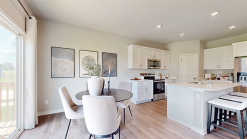Dining room table next to modern kitchen