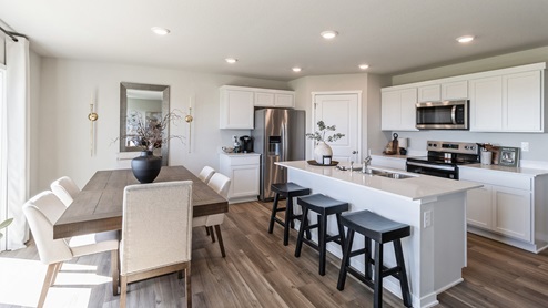 modern kitchen and dining room with wood table and white chairs