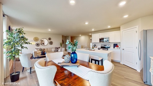 large dining area and kitchen with stainless-steel appliances