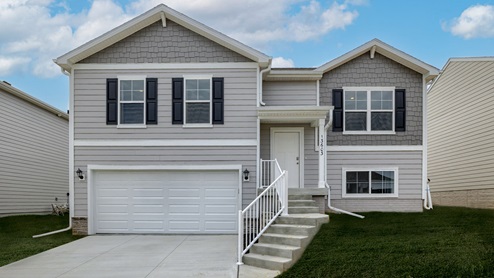 The Fremont split level home exterior with 2 car garage and stairs to front door