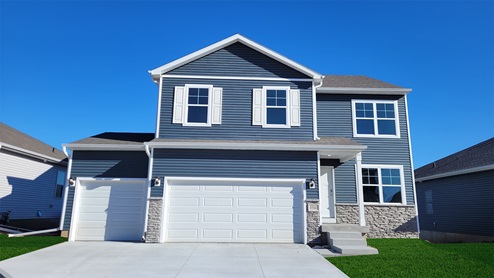 Exterior of the bellhaven with midnight siding, stone and 3 car garage