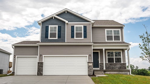 Exterior of the Bellhaven with grey siding, stone and 3 car garage