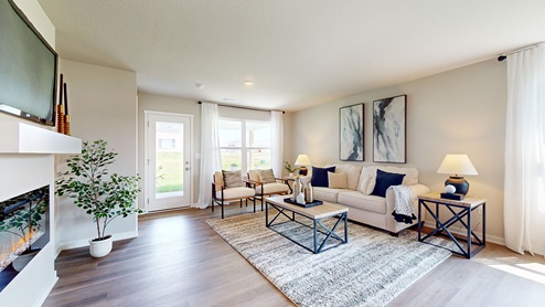 spacious living room next to window and door to patio