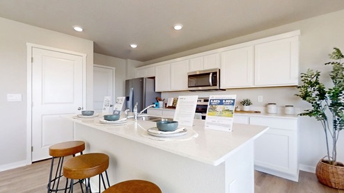 View of the Emerson kitchen with an island and white cabniets