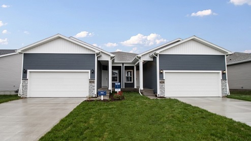 Exterior of the Olsen twinhomes with blue siding and covered front door