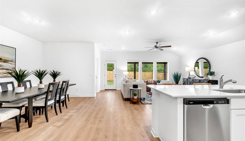 Open concept living space featuring a spacious living room area next to the dinning room.