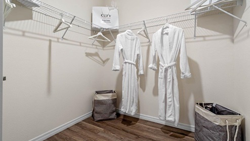 Primary bedroom walk in closet