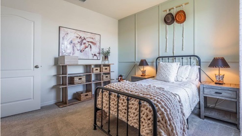 Second-floor guest room with twin size bed and carpet flooring