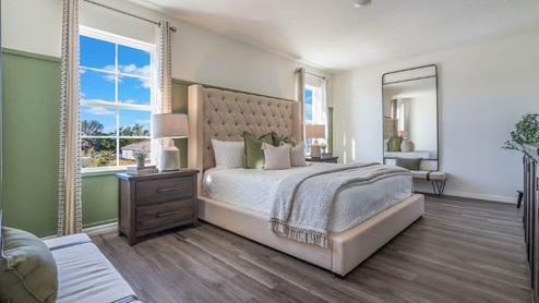 Primary bedroom with king size bed and luxury vinyl plank floors