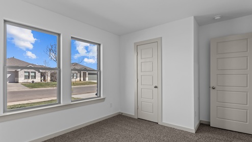 Guest bedroom with spacious closet and double windows