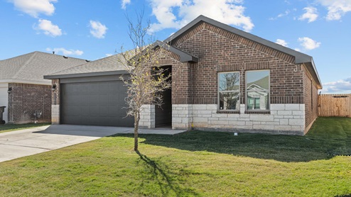 Single story home with brick, stone, covered patio with 2 car garage