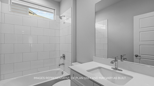 guest bathroom with single sink, vanity, and bathtub shower combo