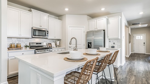 white kitchen with white island