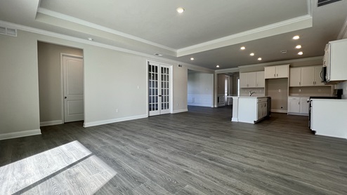 Luxury vinyl plank flooring throughout living room and kitchen.