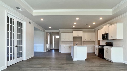 Gourmet kitchen with stainless steel appliances and luxury vinyl plank flooring.