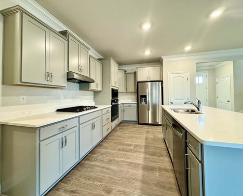 Open-concept kitchen with stainless steel appliances.