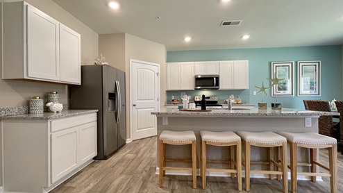 The spacious kitchen has a large island with granite countertops.