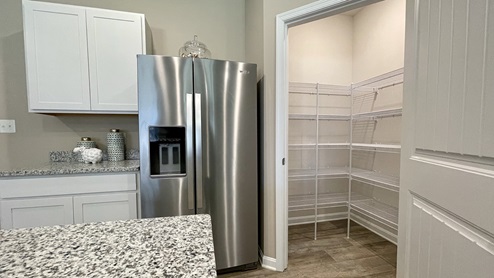 An impressive corner pantry is included in the kitchen.