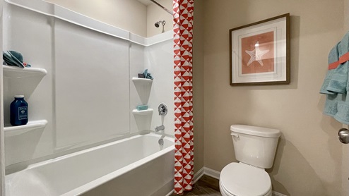 The shared hallway bathroom has a tub shower.